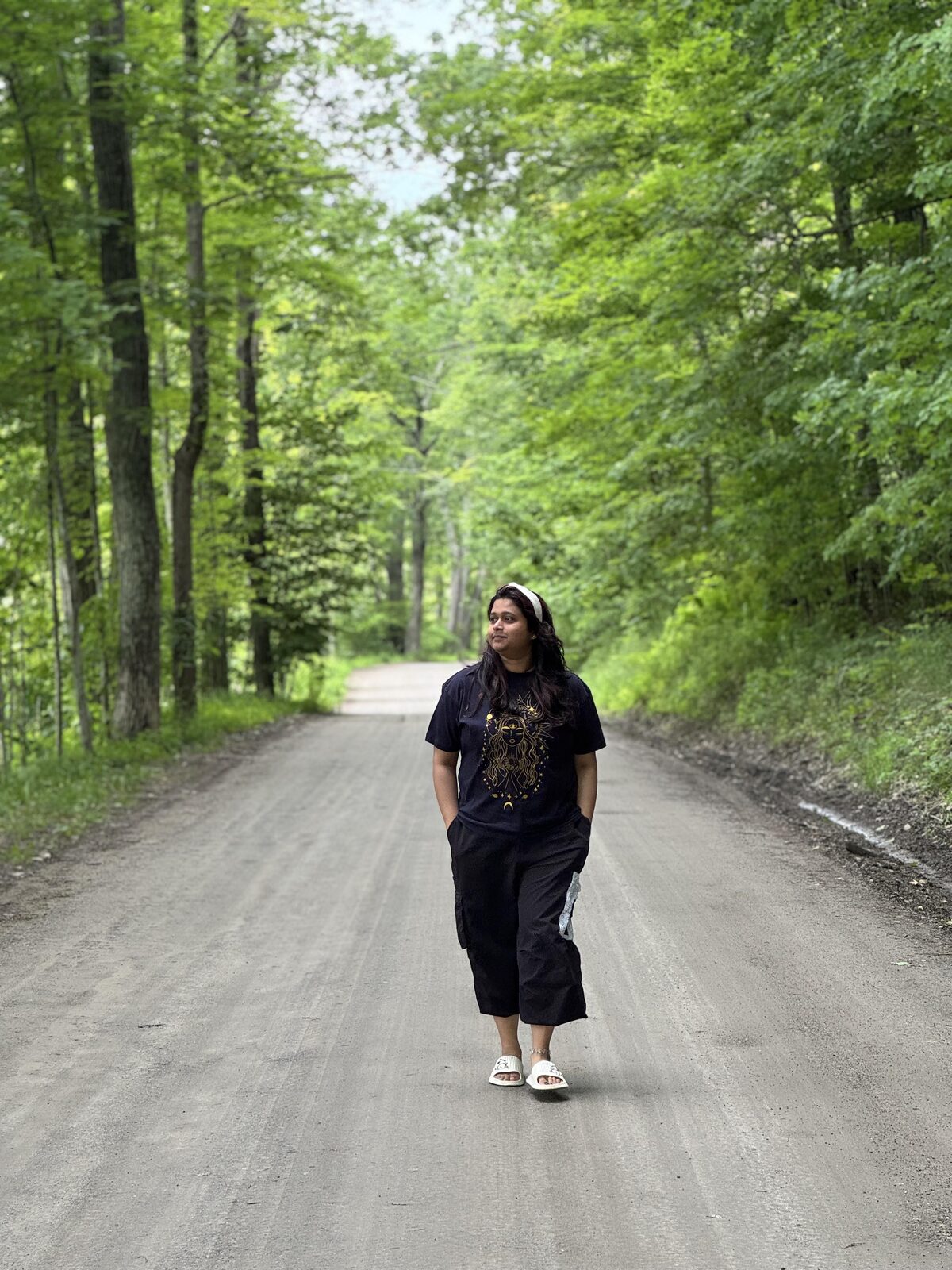 Resham Bagaria walking on a wooded road